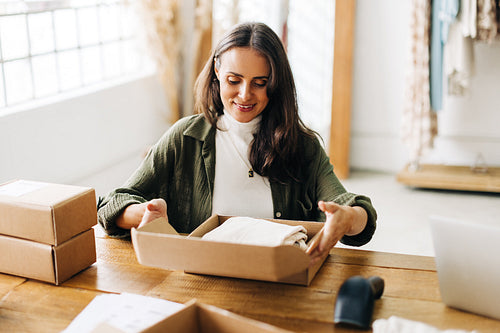 Running an ecommerce small business: Female drop shipper fulfilling orders for her online store