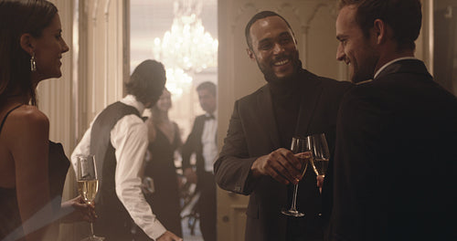 Couple are welcomed as they arrive for a party