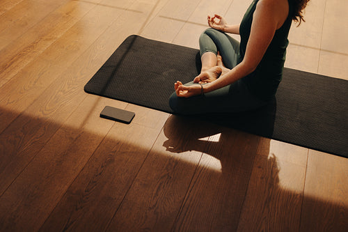 High angle view of a senior woman meditating at home