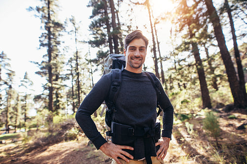 Man walking in forest wearing a backpack