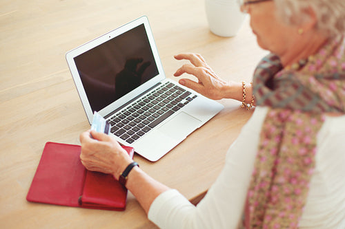 Old Woman Using Laptop with Blank Screen