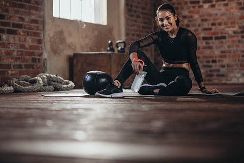 Female resting after exercise at fitness studio