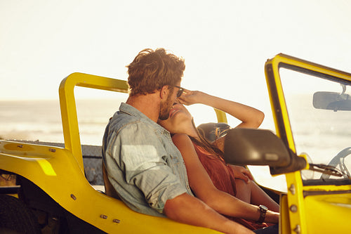 Young couple sharing a romantic moment while on a road trip
