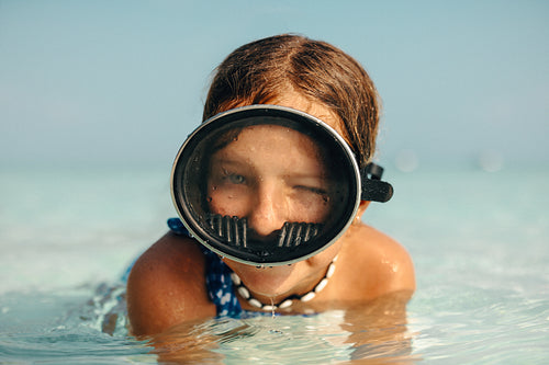Young girl snorkelling during a beach holiday with mask