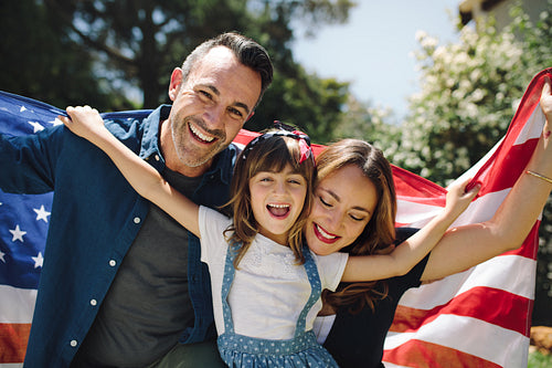 Close up of a happy family holding the american flag