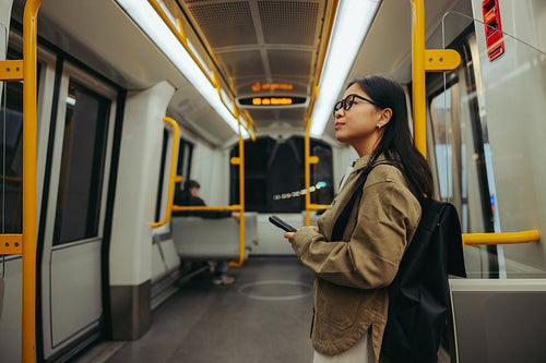 Young woman commuter on a quiet subway train