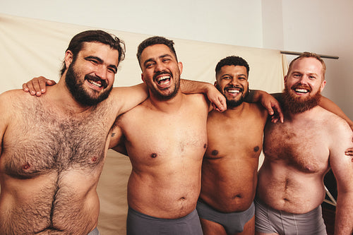 Shirtless men with their arms around each other