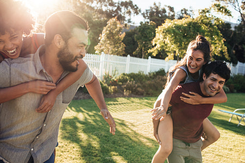 Couples playing piggyback ride race