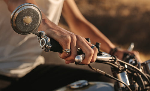 Rider's hand on the motorcycle handlebar