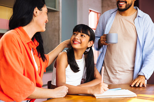 Latin American parents helping their child with homework
