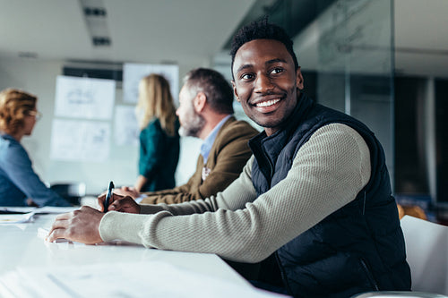 African man sitting in board room
