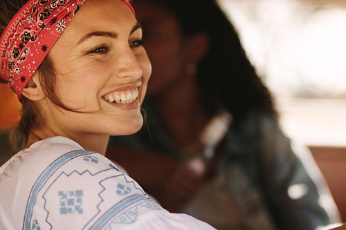 Smiling woman on road trip with friends