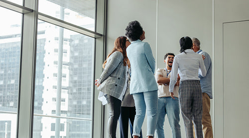 Diverse group of professionals networking and socializing at business conference