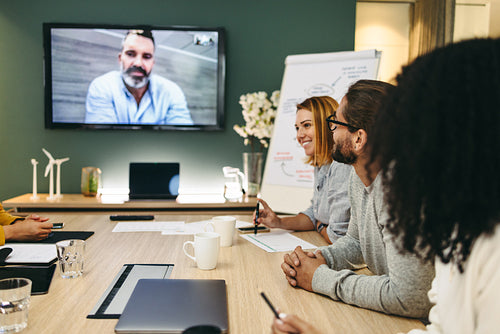 Modern businesspeople having a video conference in a boardroom