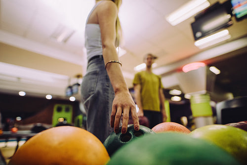 Woman choose ball for bowling game
