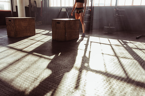Woman working out with fit box at gym
