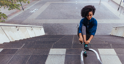 Woman runner tying her shoe lace