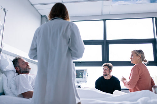 Female physician visiting patient in hospital room