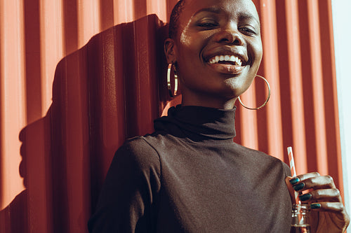 Attractive african woman with a cola