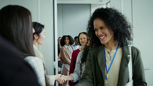 Happy attendees shaking hands at conference