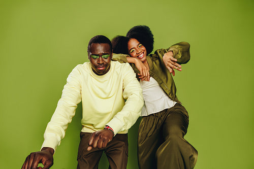 Friends dance together as a playful duo in the studio with modern style