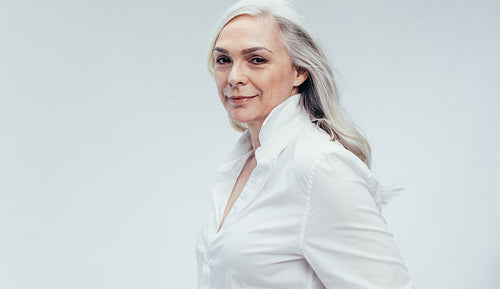 Stylish senior woman in white casuals