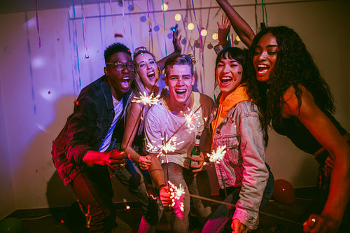 Group of young friends celebrating at a house party