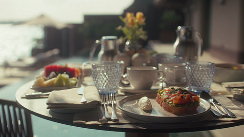 Luxury breakfast setup at private beachfront villa overlooking the pool