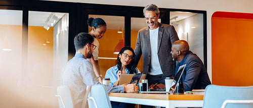 A diverse group of professionals discussing ideas around a table