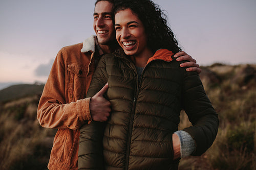 Smiling couple enjoying the view from mountain