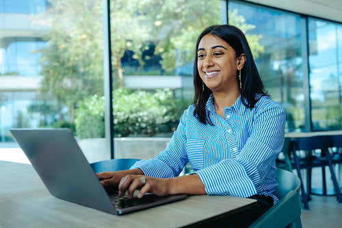 Indian businesswoman working on laptop in modern office