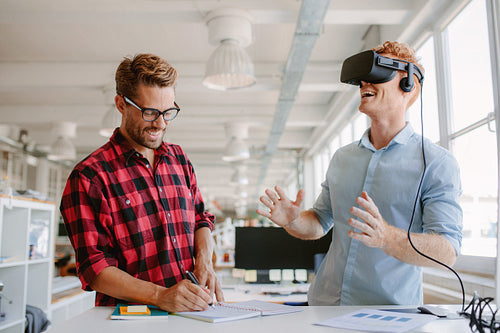 Developers testing virtual reality glasses in office