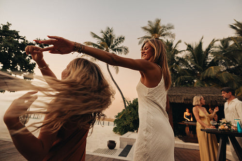 Family dancing together at tropical resort. Luxury family vacation