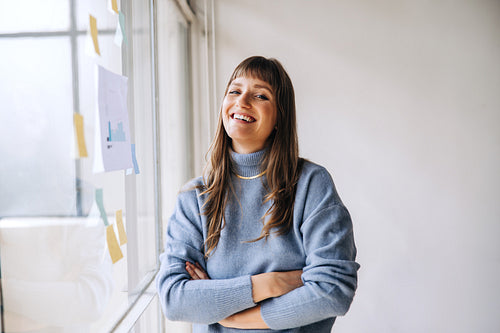 Young businesswoman smiling at the camera in a creative office