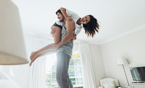 Couple in playful mood in bedroom