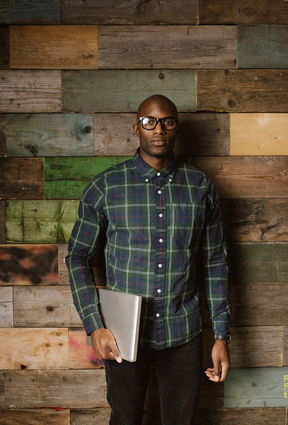 Portrait of serious young african man with a laptop 
