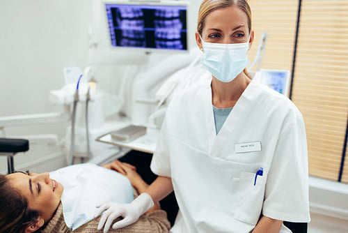 Dental doctor in her clinic with female patient