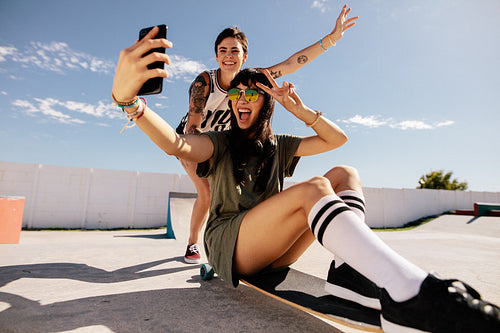 Girls skateboarding and taking selfie