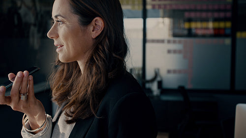 Businesswoman talking on speakerphone