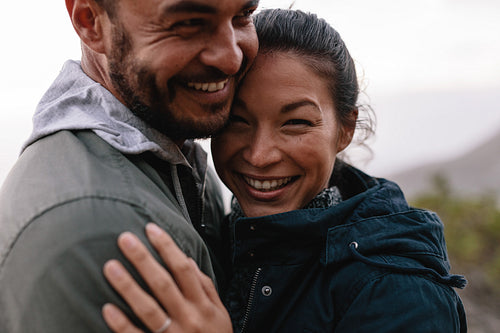 Romantic young man and woman embracing in countryside