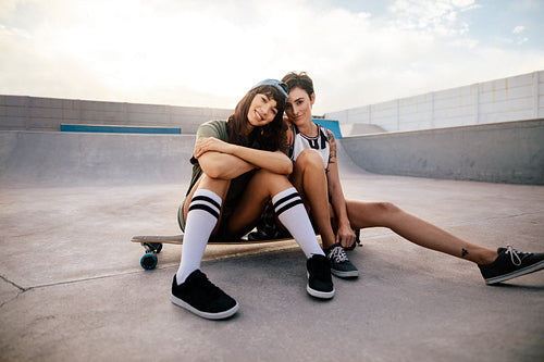 Female skateboarders hanging out at skate park