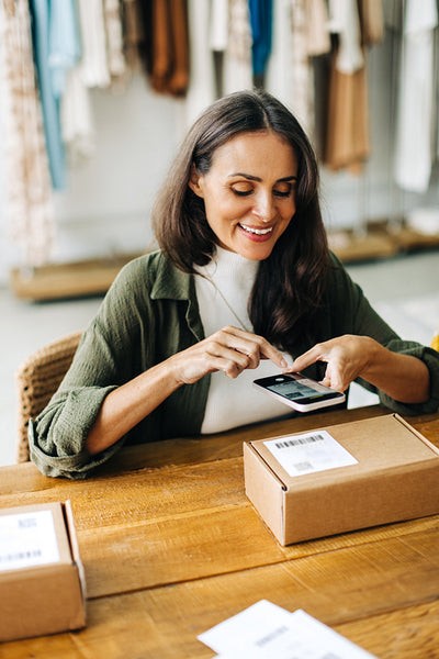 Online store owner scanning a qr code with a mobile barcode scanner for dropshipping