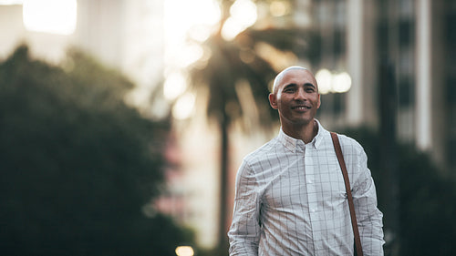 Businessman walking on street to office