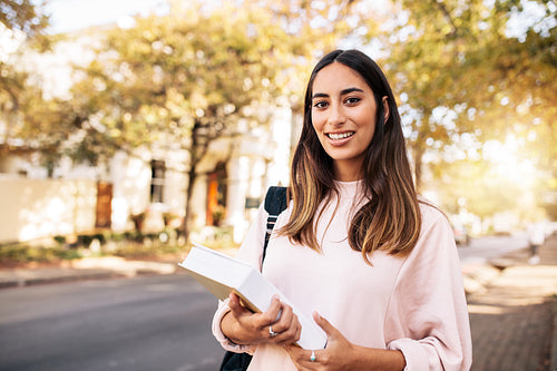 Female student with book in college campus