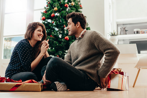 Young couple celebrating Christmas at home.
