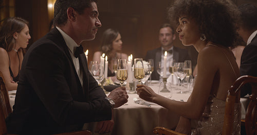 Cute girl talking with her mother at dinner party