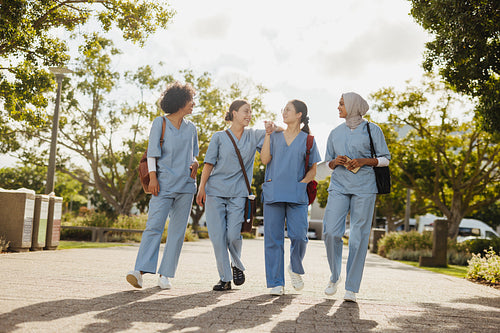 Group of multicultural medical students chatting on their way back from class