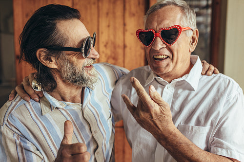 Elderly friends with crazy eyewear having fun