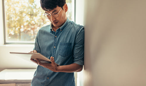 Man using digital tablet at home