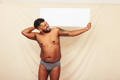 Natural body activist holding up a white banner